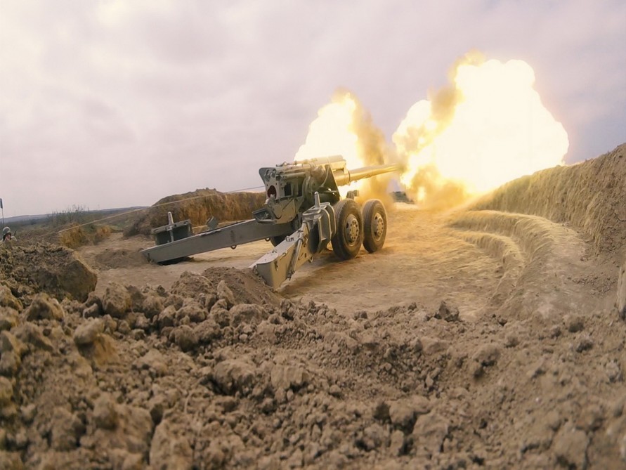 Artillery units stationed in frontline zone conduct live-fire exercises